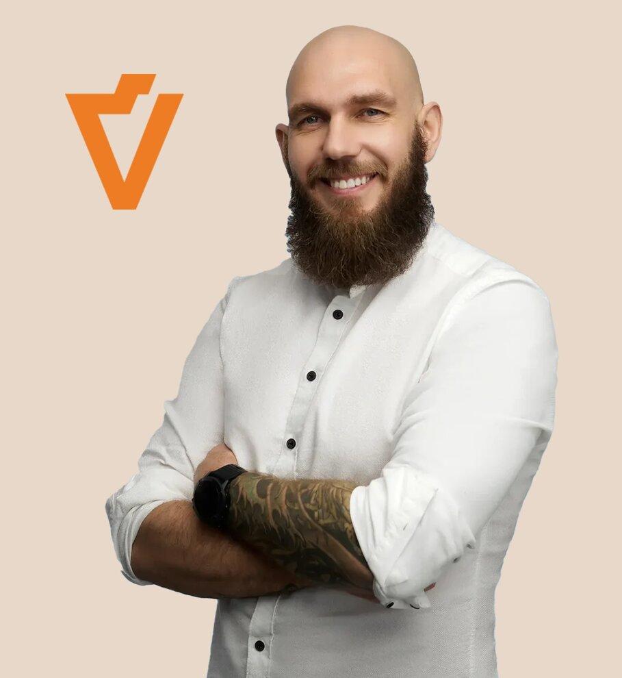Laimantas Pleikys, the founder of Venditioni, standing against a light orange background with the Venditioni logo displayed beside him.